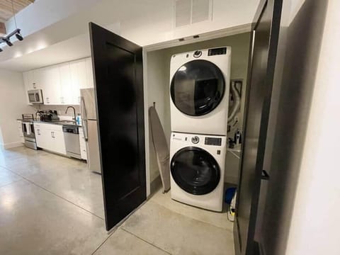 Stacked washer/dryer in unit