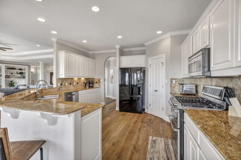 Large, well-appointed kitchen with additional seating at the bar