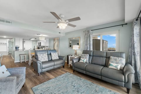 Living room with leather reclining sofa and loveseat.