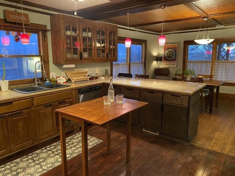 OPEN FLOW KITCHEN WITH SPACIOUS GRANITE COUNTER AND DINING AREA BEYOND