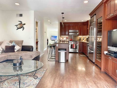 Large kitchen and sitting area located off of kitchen with TV.