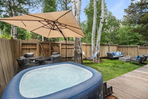 Fenced private yard with hot tub, BBQ, dining and lounging