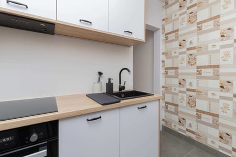 A wider view of the kitchen, showcasing the ample storage space.