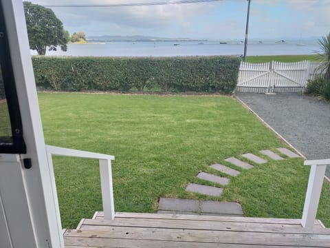 Relax on the on the front deck and enjoy the view or wander across to the beach