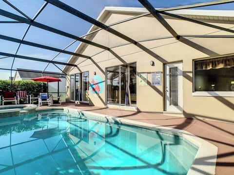 Take a refreshing dip in your private screened-in pool under the Florida sun.