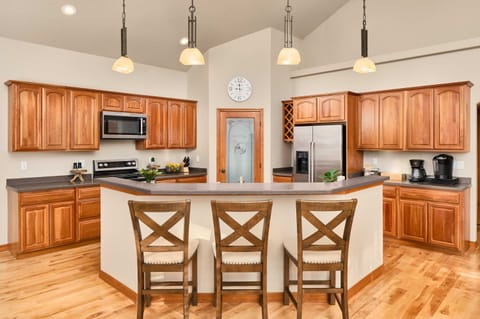Kitchen with island, microwave, oven, fridge, coffee station, pantry (upstairs)