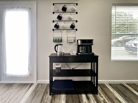 A small coffee bar with coffee pot that will do pods or a full pot.