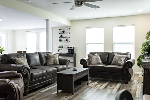 Living Room with love seat, couch and recliner to sit and relax on.