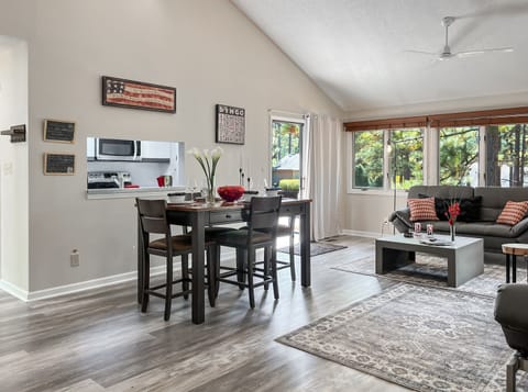 The open living/dining area is surrounded by views of gorgeous pines!