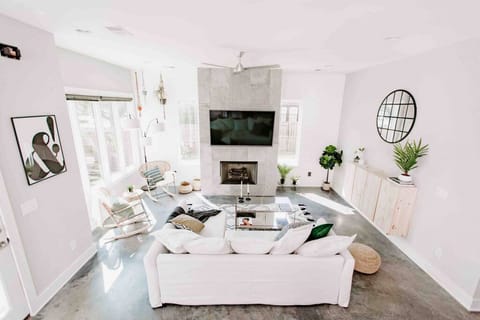 Cozy living room with a Smart TV, Queen sleep sofa, lots of natural light, custom blinds, direct access to the private fenced in yard, and plenty of seating.
