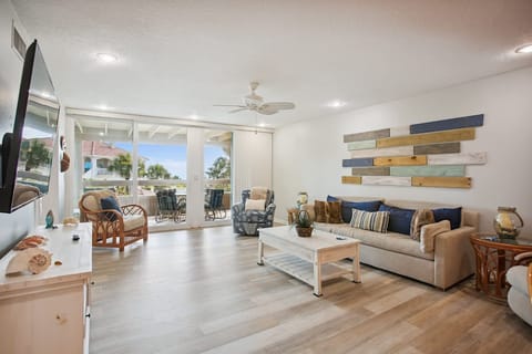 - Bright and airy living space with coastal décor and a large sliding door to the balcony
- Comfortable sofa and armchairs offer plenty of seating for relaxation
- Enjoy indoor outdoor living with a seamless flow to the ocean view patio
