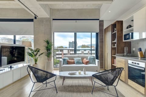 Bright open-concept living area with a fully equipped kitchen and plenty of natural light.