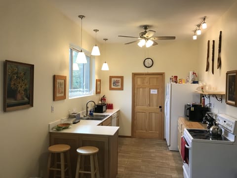 Full Kitchen with ceiling fan and large south facing window. Lots of lights.