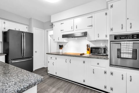 The kitchen has a unique antique feel with the original cabinetry. Upgraded with new flooring and black granite countertops. Fully equipped with everything you need to create a lovely meal for friends and family.