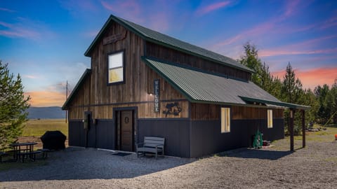 As the sun sets, The Cub House radiates warmth against the tranquil backdrop of Island Park. Its rustic charm and inviting glow beckon travelers to unwind and embrace the serenity of nature's embrace.