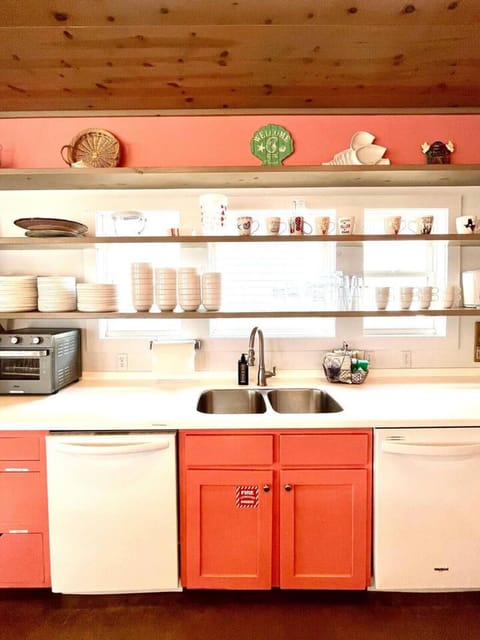 Fully equipped kitchen with open shelving and plenty of prep space.