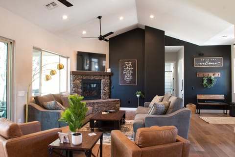Open floor plan - great room with gas fireplace, comfy couches & 65 inch TV