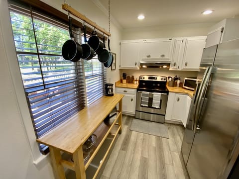 Furnished- Kitchen with cookware, plates, glasses, utensils, coffee maker, etc. 