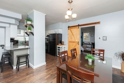 Dining area & kitchen. Table seating for 6 people, with 3 more at the bar