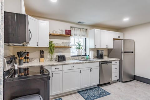 Full size kitchen with refrigerator, electric range, microwave, and dishwasher. 