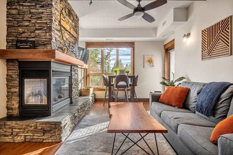 Living room with a gas-lit fireplace, Smart TV, board games, and cozy seating options, including a queen-sized sofa bed (all linens provided.)