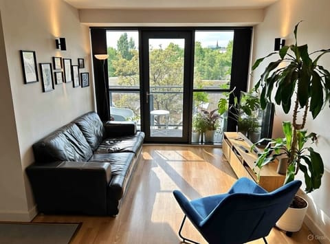 Living room with 56" TV & access to a large balcony.