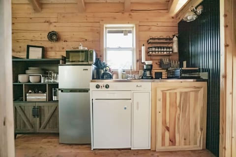 Kitchenette includes minifridge/freezer, 2 burner gas stove, and microwave