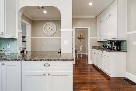 Adjacent to the kitchen is a coffee and beverage area with a dual coffee maker, Keurig, and full-size coffee maker for large groups. It’s stocked with coffee, filters, Coffee-mate, and sugar, ensuring you have everything needed for a perfect brew.