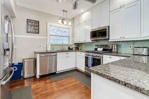 This fully equipped kitchen features a fridge, gas oven and stove, dishwasher, microwave, toaster, and all essential dishes, utensils, knives, and cookware. It also includes a variety of spices to enhance your cooking experience.