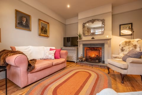 Norfolk House, Heacham: A warm and inviting sitting room with open fire