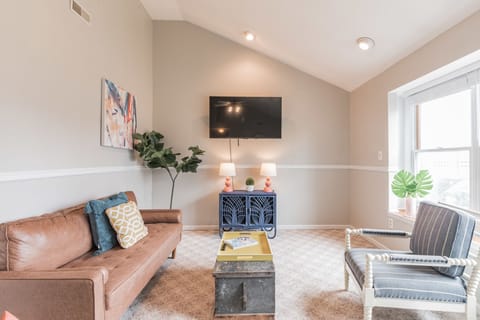 Front living room with smart tv and plenty of comfortable seating.