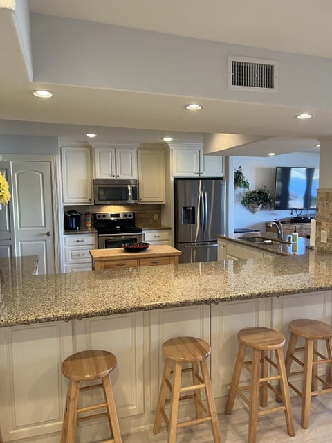 1st floor fully stocked kitchen with extra seating around the counters.