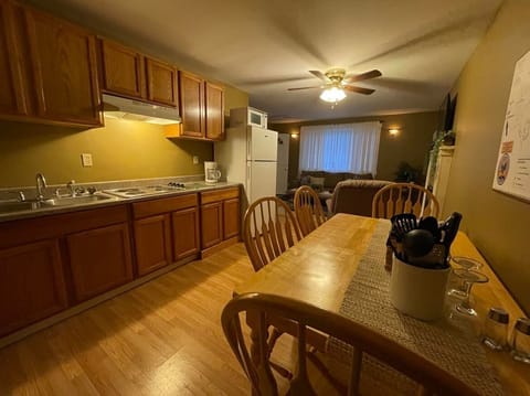 Kitchen offers stove & full size refrigerator, dinning table, pots, pans, dishes