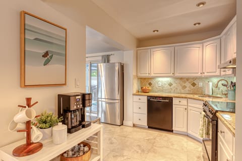 Galley kitchen with coffee bar/station.