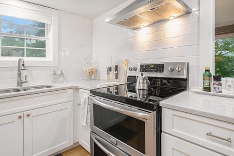 Kitchen w/  double oven, industrial hood, and fully stocked with cookware