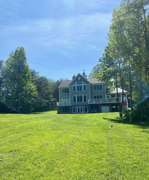 Back of house with large yard for lawn games