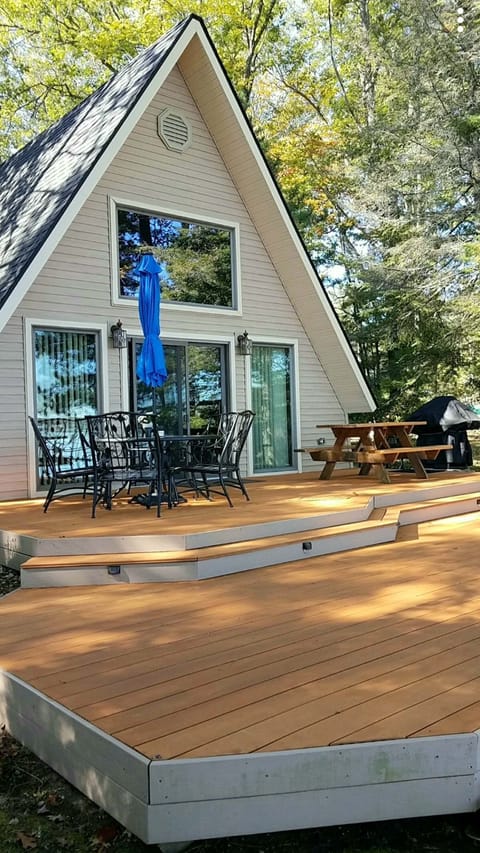 Large deck with beach chairs  and gas grill.