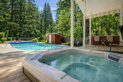 Soak in your private hot tub while gazing at towering evergreens, then dive into the refreshing pool steps away.