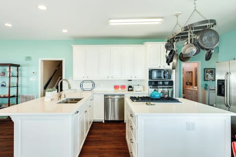 Spacious kitchen with crisp white cabinets and counters