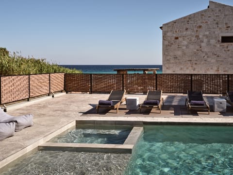 The villa features sea side views, and a pool with hydromassage features. 