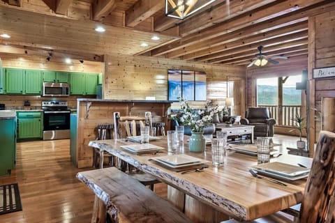Gorgeous wood table in dining area open to full kitchen and living room