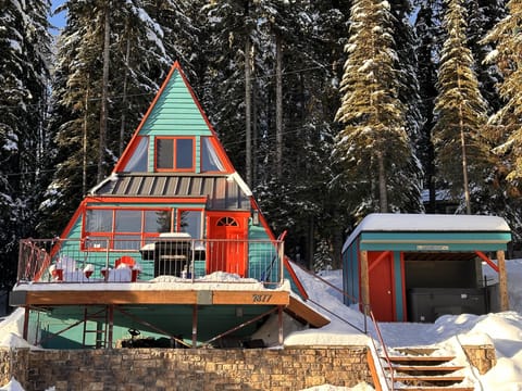Heimo Haus, driveway is in front of the rock wall that accomodates 2 cars.