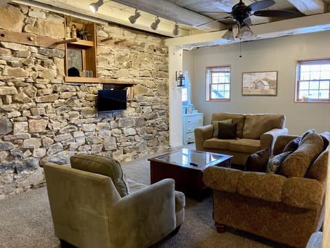 Main living area features a large comfy seating group and TV.