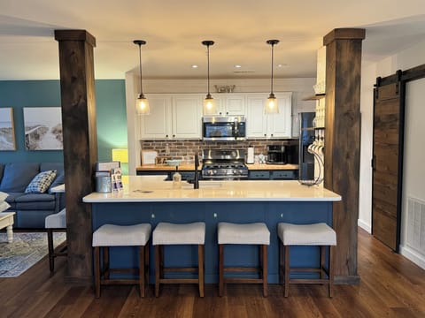 Kitchen: Quartz countertop center island/sink. Full open concept floor plan.