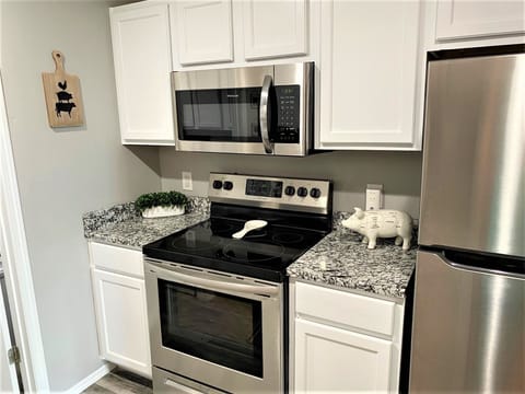 Newly remodeled kitchen has full size appliances and granite countertops