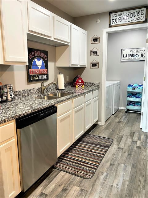 Newly remodeled kitchen leads to laundry room with a washer and dryer