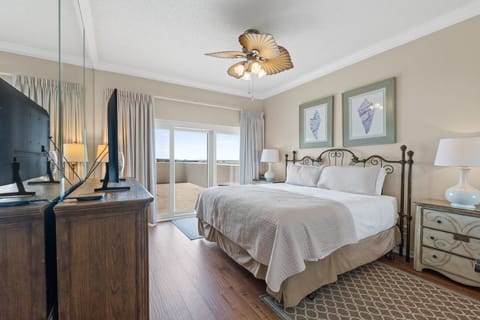 Main bedroom has large flat screen TV, cable, free WiFi, dresser, & private balcony with Gulf views.
