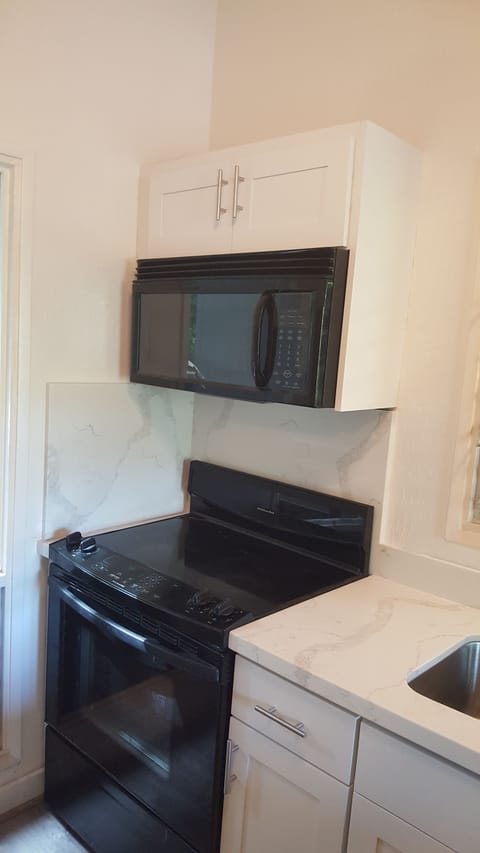 Electric range with built in overhead microwave.