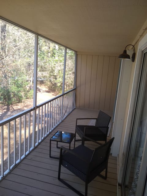 Screened deck with furniture on the 2nd floor. Both bedrooms open to the deck.