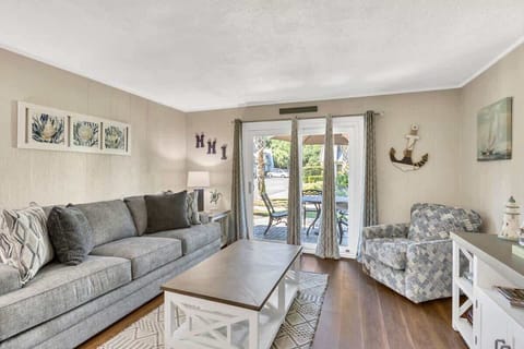 Cozy living room with a comfortable sofa and direct access to an outdoor patio.